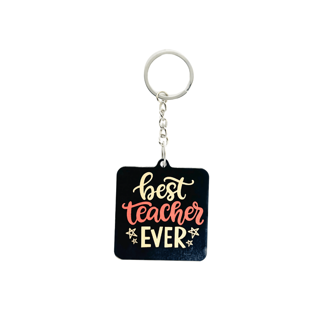 Best Teacher Ever black acrylic keychain – teacher appreciation gift in Kuwait with bold red and gold text.