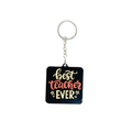 Best Teacher Ever black acrylic keychain – teacher appreciation gift in Kuwait with bold red and gold text.